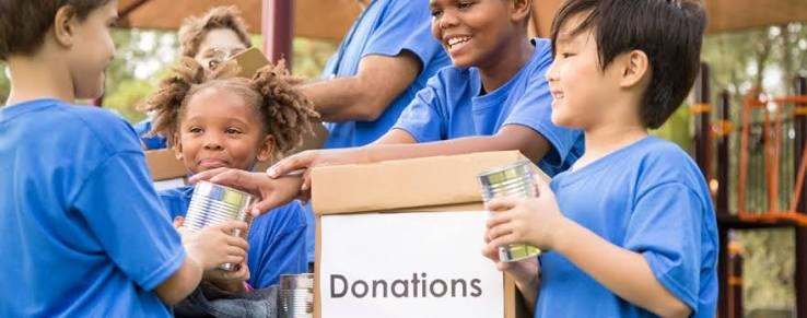 Volunteers with a donation box