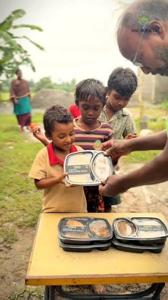 Volunteer serving food packets